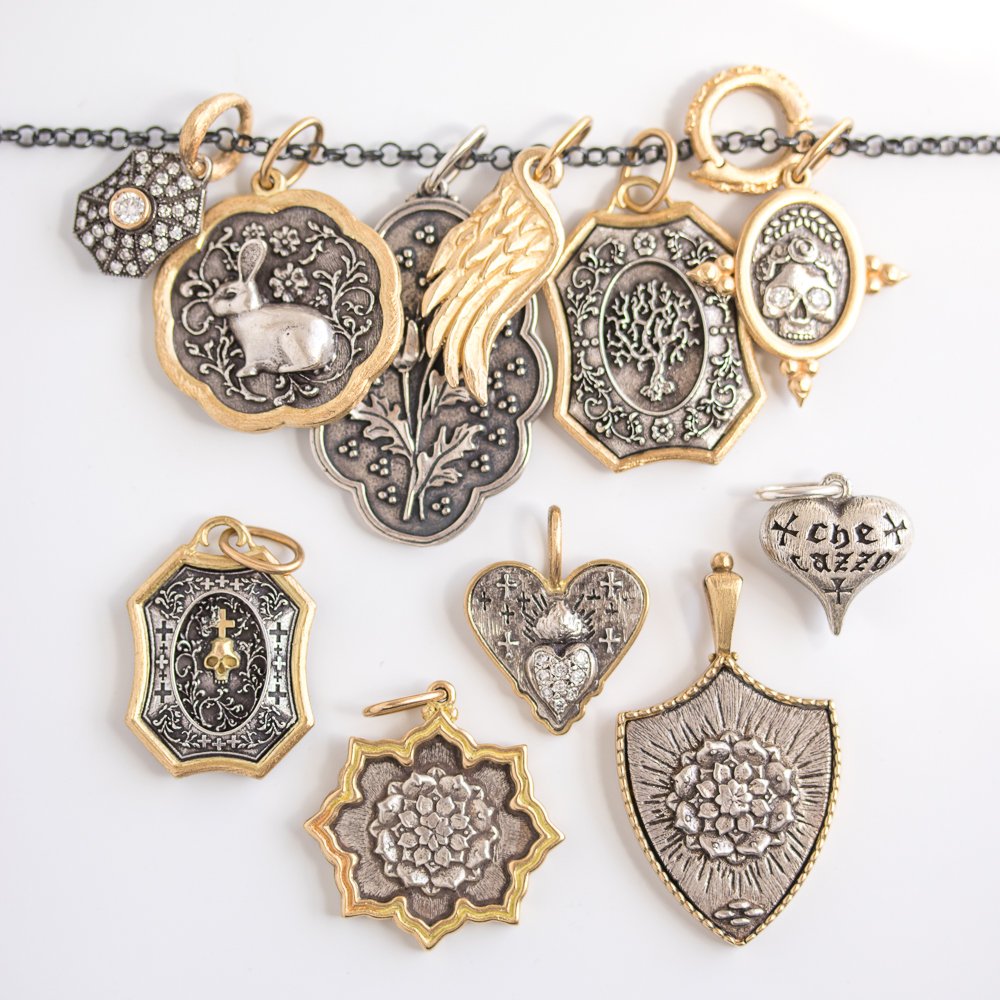 Gold and silver charms by Erica Molinari