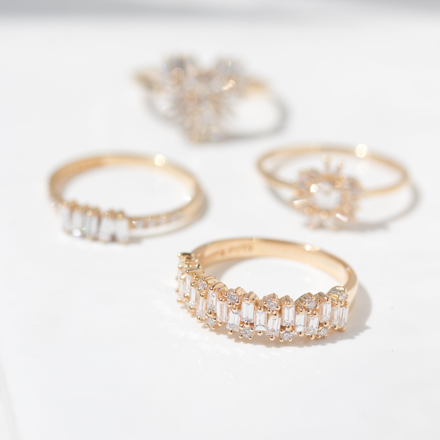 Gold and baguette diamond rings by Suzanne Kalan