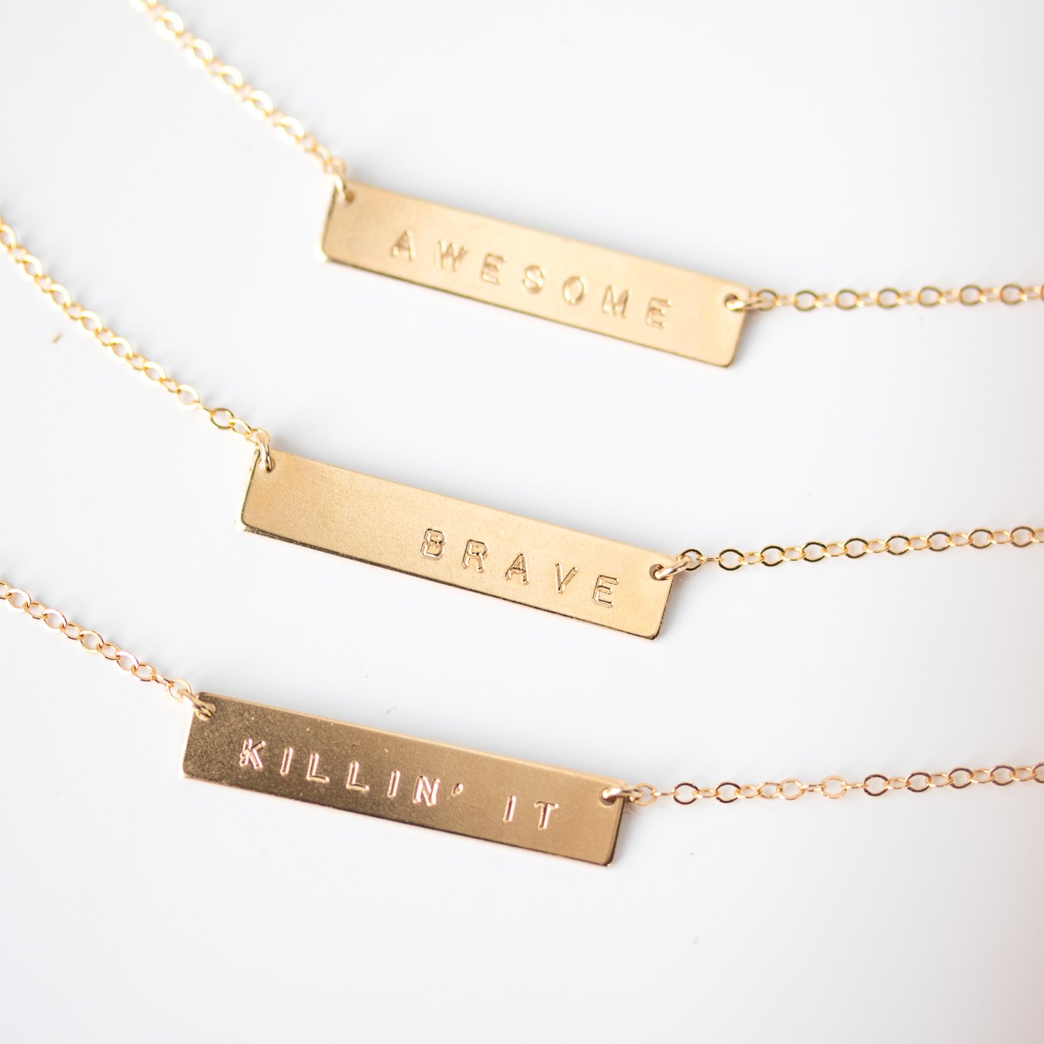 Gold word necklace by Urban Smith