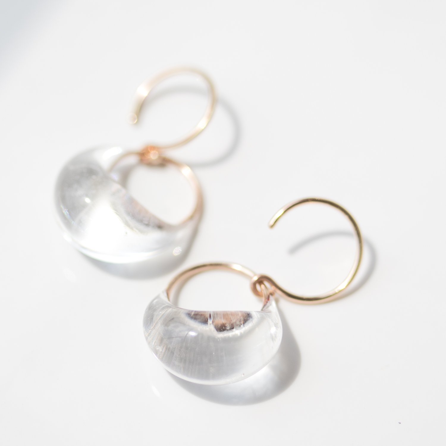 Clear droplet earrings in gold with glass by Jess Panza