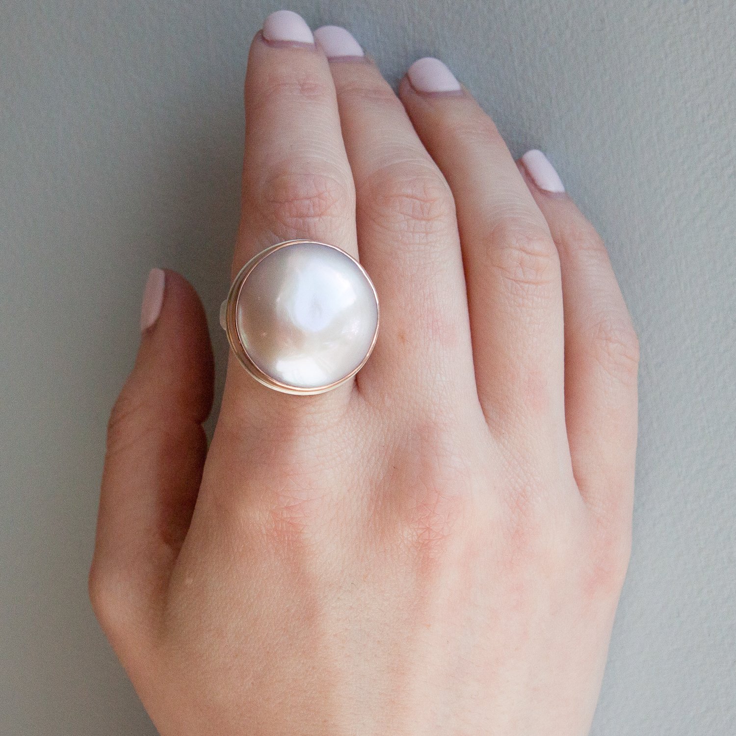Jamie Joseph: SS & 14k rose gold ring with large round mabe pearl on groovy band