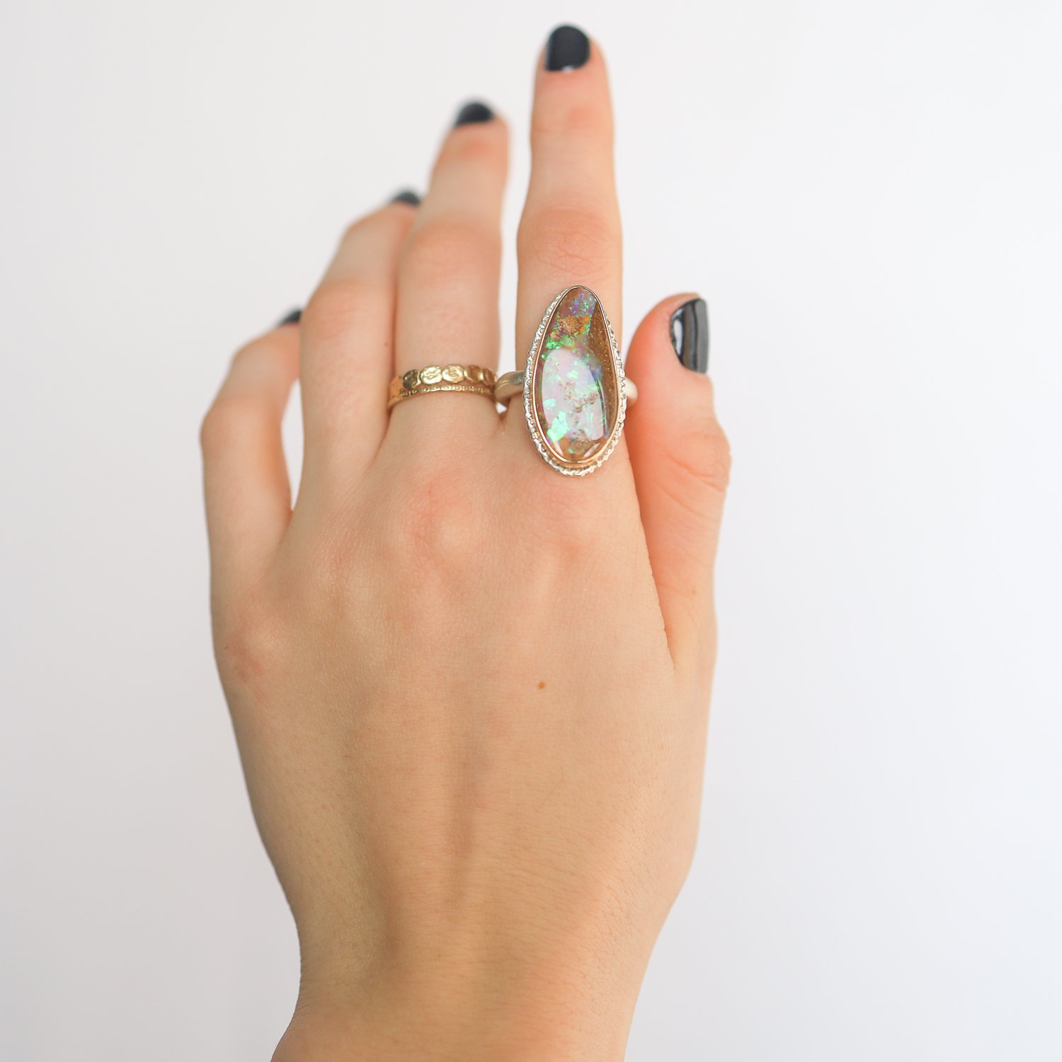 Jamie Joseph: SS & 14k gold ring with vertical asymmetrical opalized wood on organic band