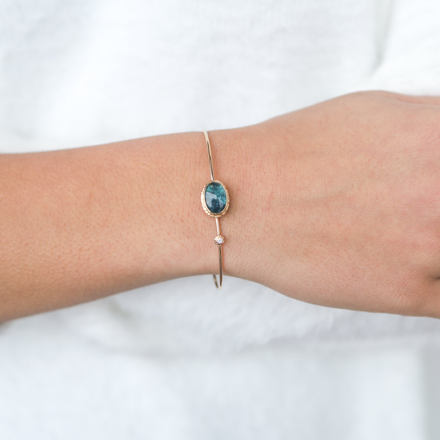 Jamie Joseph:14k Gold bracelet w/ oval smooth indicolite on ruffled platform w .03ct diamond accent