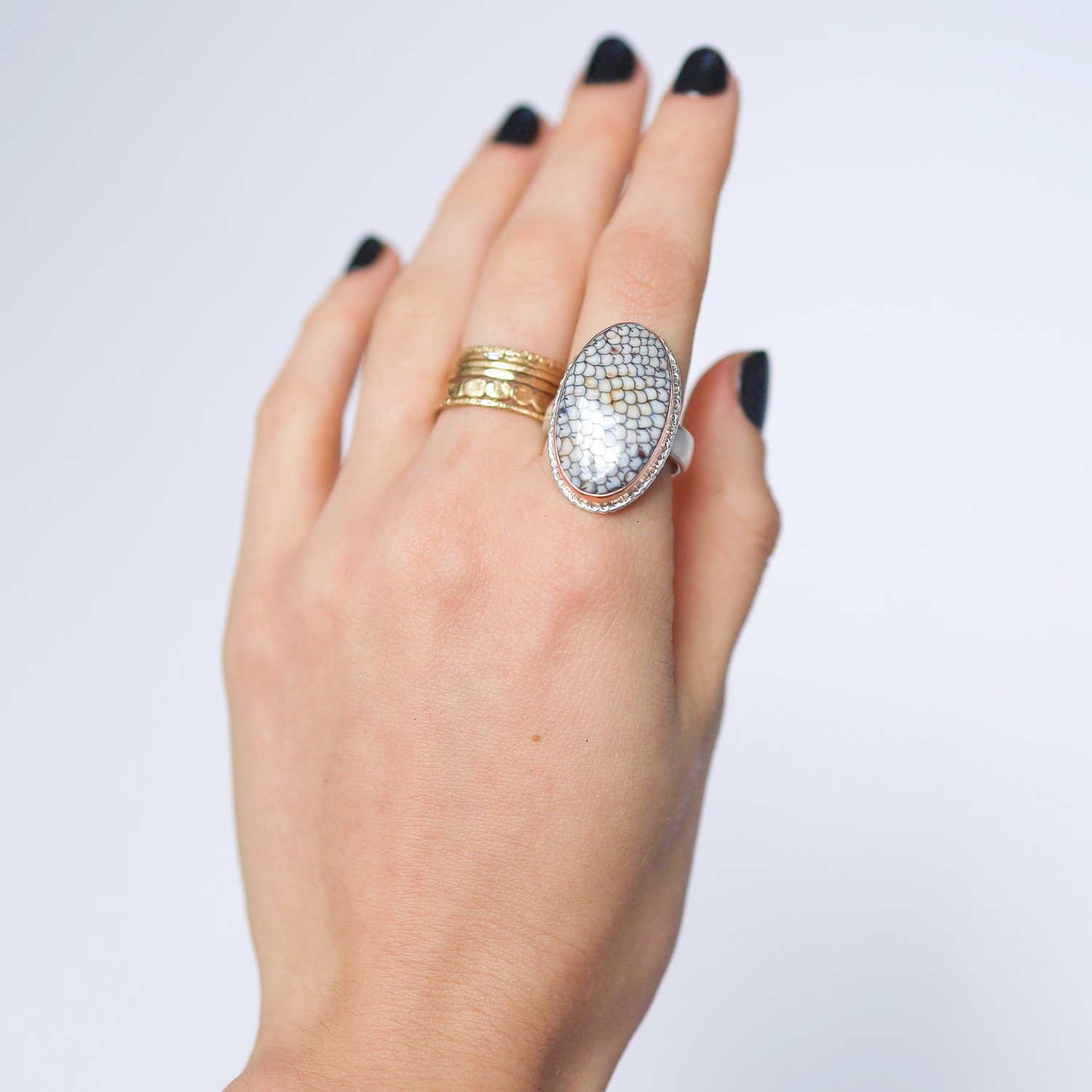 Jamie Joseph: Ring, Vertical oval, 14K rose gold bezel set snakeskin agate on lava platform, Sterling silver comfort band, Stone measures 1 x 9/16, Currently available in size 7 3/4