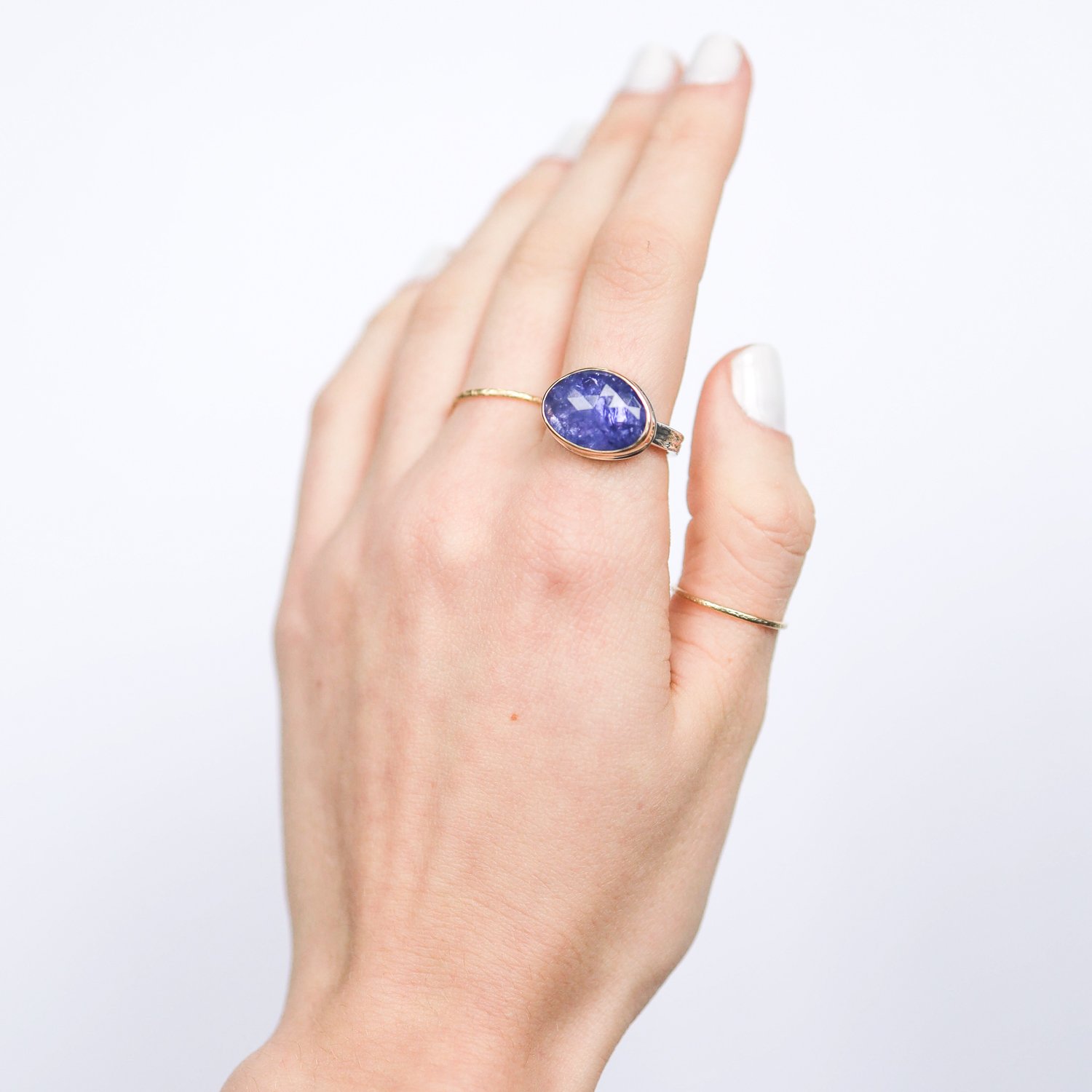 Jamie Joseph: Ring, Small asymmetrical rose cut, 14K yellow gold bezel set tanzanite, Sterling silver medium vine band, Stone measures 7/16 x 9/16, Currently available in size 6 3/4