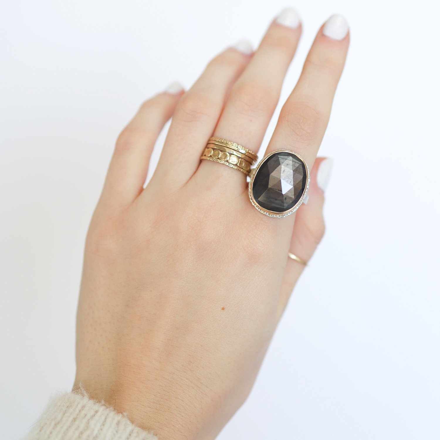 Jamie Joseph: Ring, Vertical oval rose cut, 14K gold bezel set brown sapphire on lava platform, Sterling silver X band, Stone measures 13/16 x 5/8, Currently available in size 7