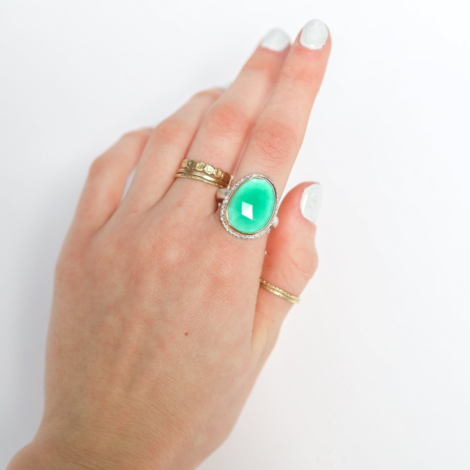 Jamie Joseph: Ring, Vertical asymmetrical rose cut, 14K gold bezel set green onyx on lava platform, Sterling silver organic band, Stone measures 3/4 x 9/16, Currently available in size 7 1/4
