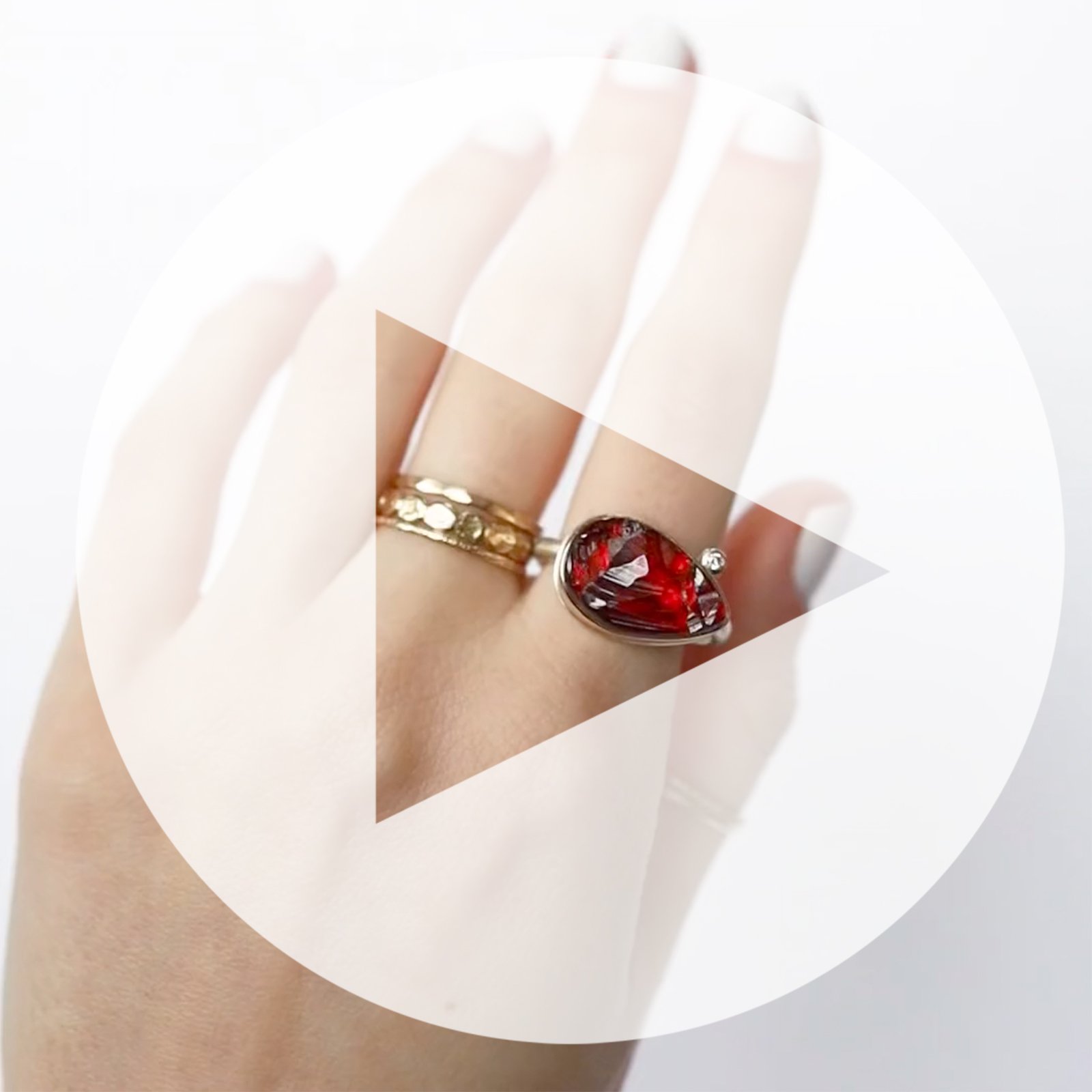 Jamie Joseph: Ring, Teardrop surface cut, 14K yellow gold bezel set garnet, Satellite diamond, .03ct, Sterling silver Egyptian band, Stone measures 7/16 x 11/16, Currently available in size 7 1/2