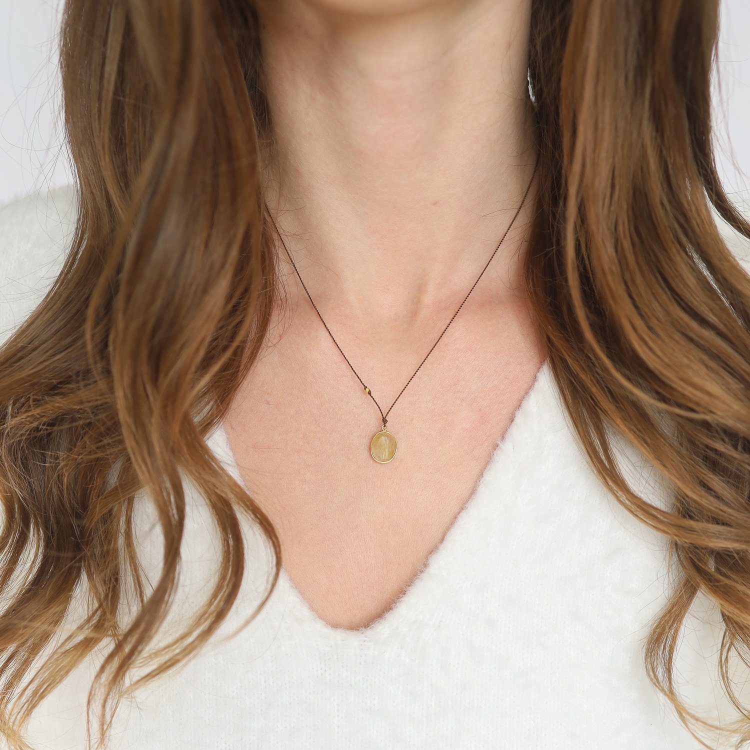 Margaret Solow: Necklace, Rutilated quartz, 18K yellow gold, Nylon cord measures 17, Pendant measures 9/16 x 3/8 including bail