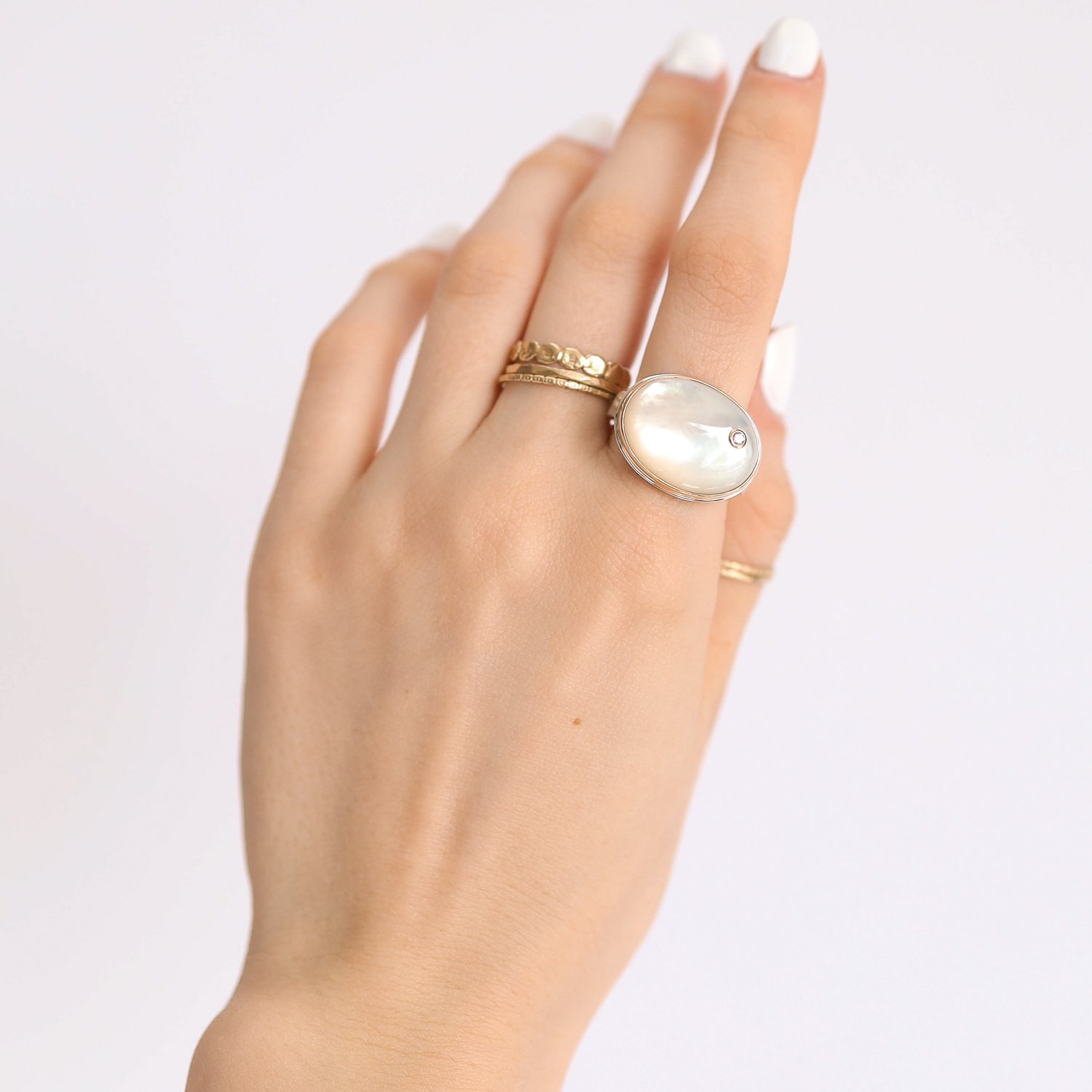 Jamie Joseph: Ring, Oval, 14K gold bezel set mother of pearl, Diamond, .03ct, Sterling silver tapered X band, Stone measures 9/16 x 3/4, Currently available in size 7 3/4