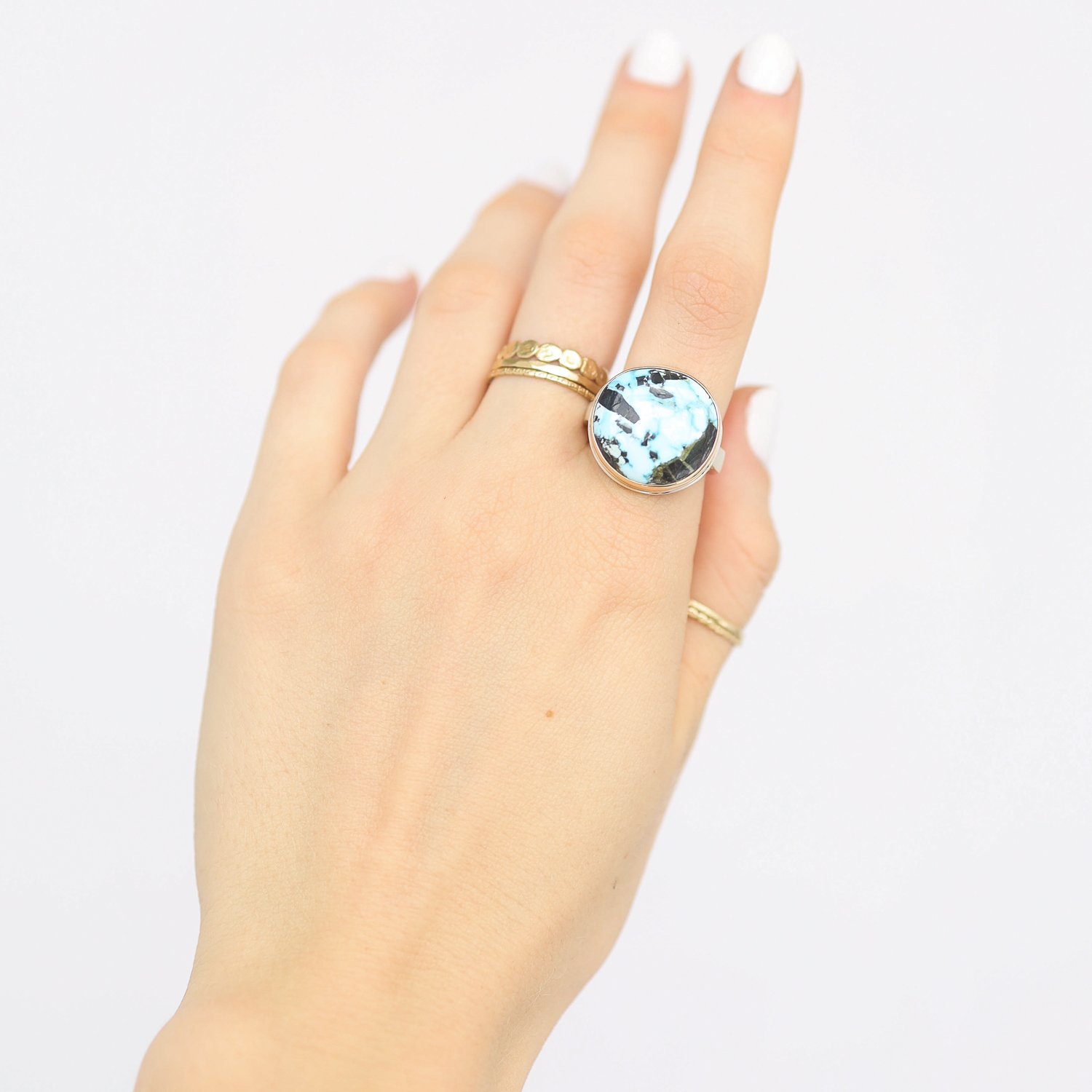 Jamie Joseph: Ring, Asymmetrical, 14K gold bezel set Sierra Nevada Turquoise, Sterling silver soft live edge band, Stone measures 11/16 x 11/16, Currently available in size 7 1/2