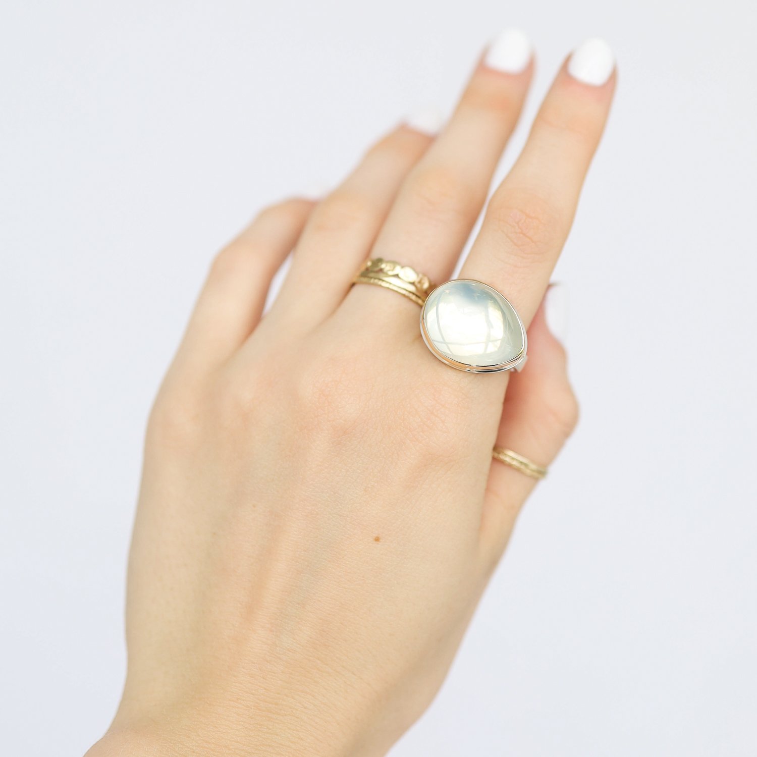Jamie Joseph: Ring, Teardrop smooth, 14K gold bezel set green moonstone, Sterling silver soft live edge band, Stone measures 5/8 x 13/16, Currently available in size 7 1/2