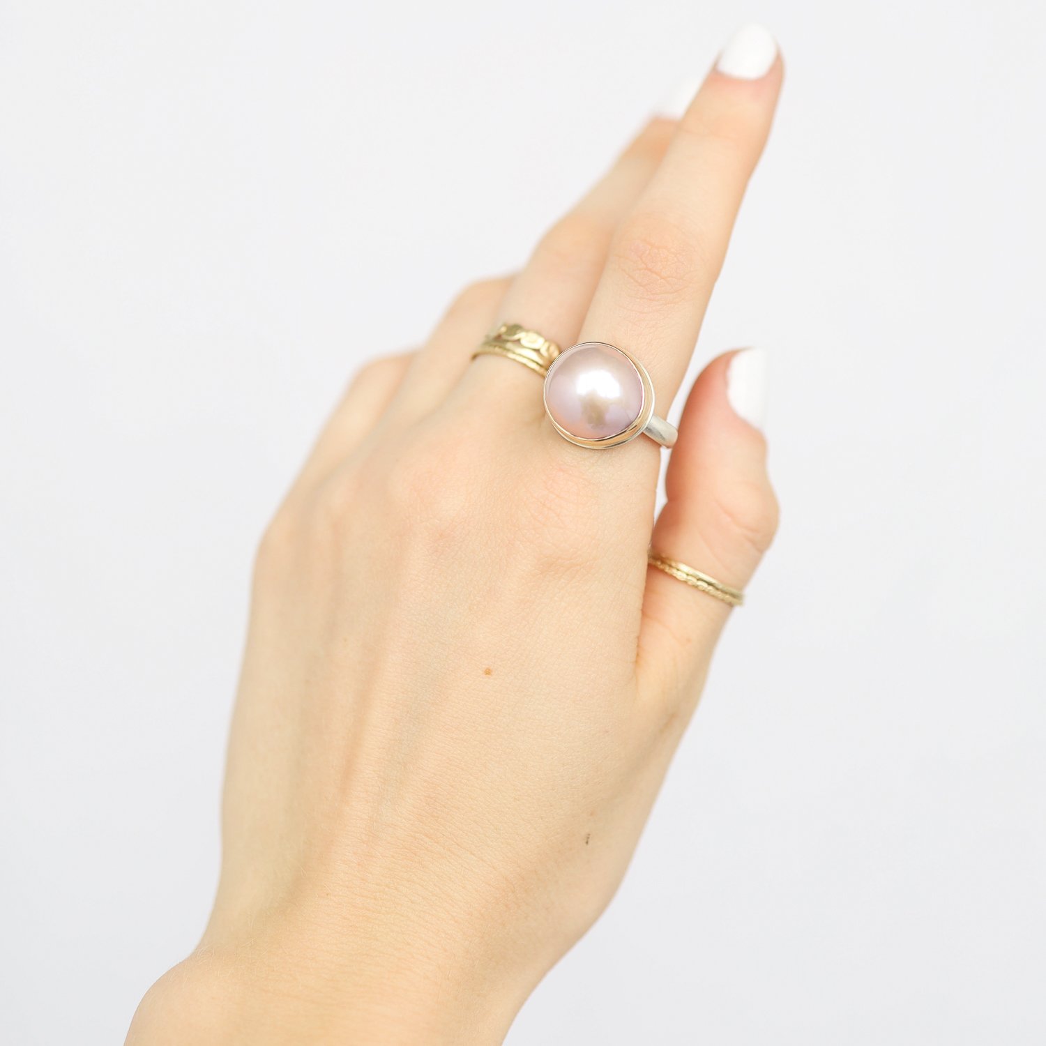 Jamie Joseph: Ring, Round, 14K gold bezel set pink cultured pearl, Sterling silver middle groovy band, Stone measures 9/16 x 9/16, Currently available in size 7 1/4