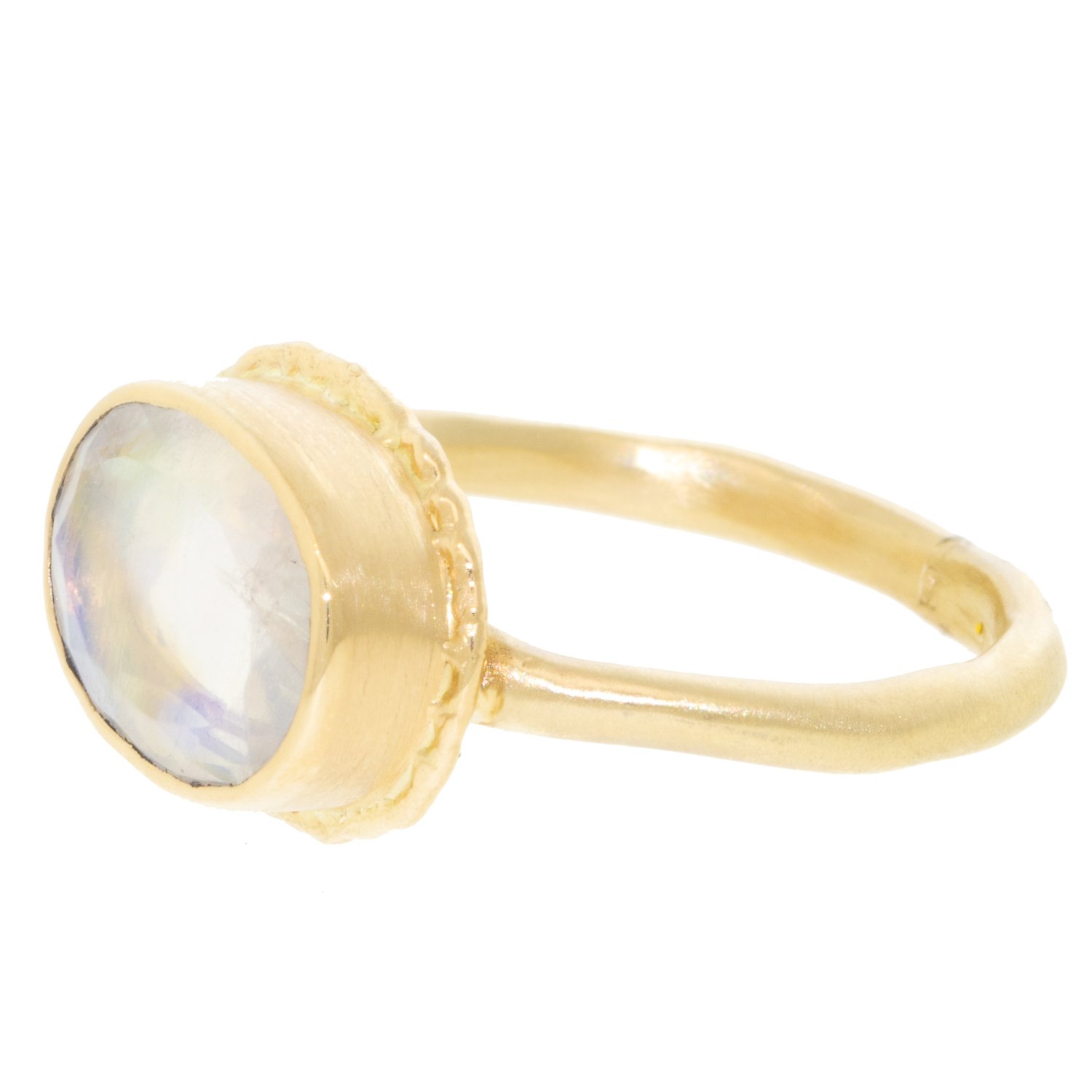 Jamie Joseph: Ring, Small oval table up, 14K gold bezel set white rainbow moonstone on open back ruffled platform, 14K dent band, Stone measures 5/16 x 1/2, Currently available in size 7 1/2