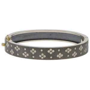 Rene Escobar: SHAYNA 8MM. SS hinged bangle featuring an 18k YG push button style clasp set with 0.65CT of WH diamonds.