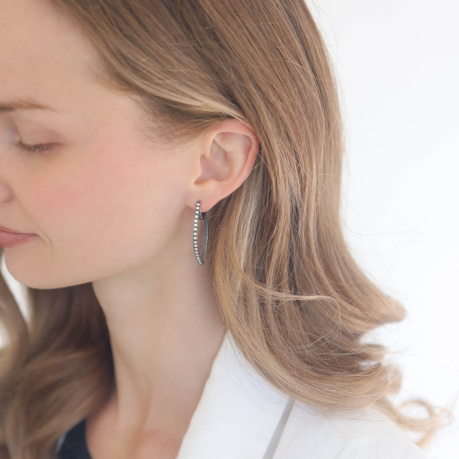 Rene Escobar: SS earrings set with 0.35CT in WH diamonds and 18k YG post